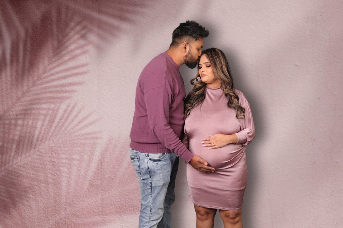A loving couple shares a tender moment, celebrating pregnancy and new life.