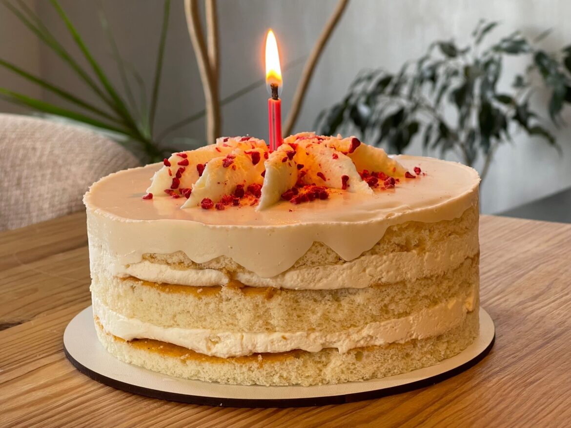 A delightful birthday cake with a lit candle, perfect for celebrations.