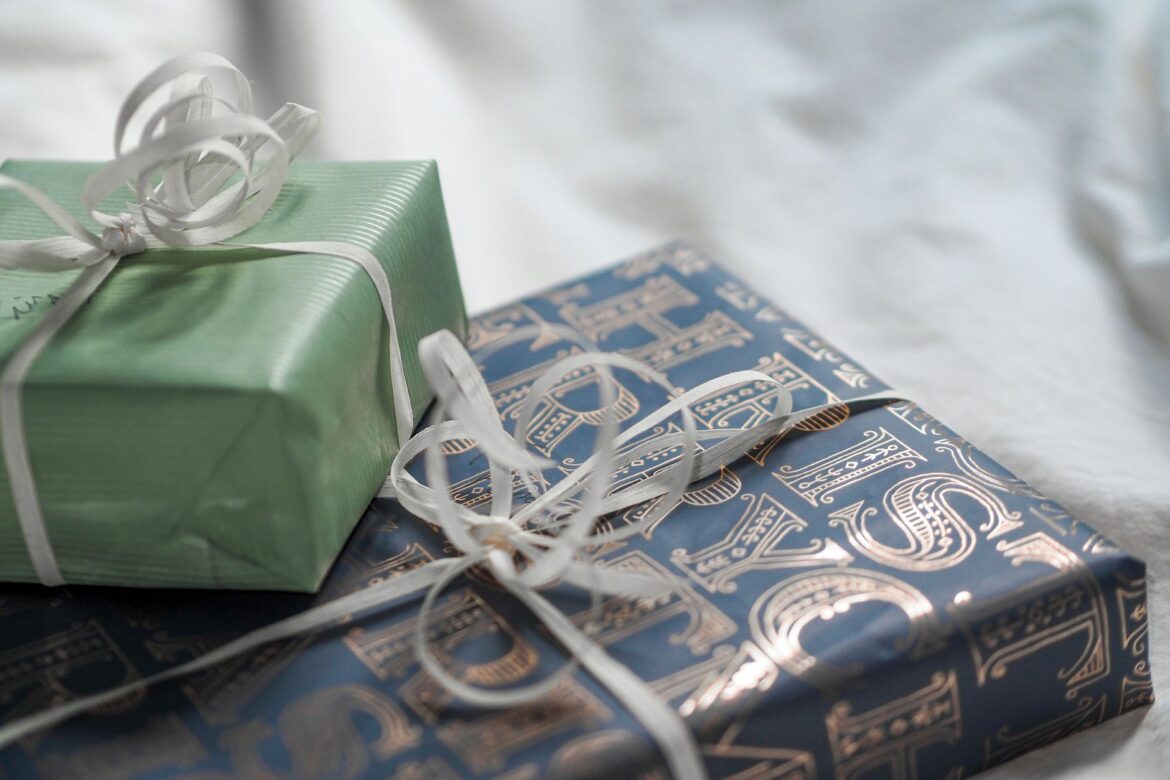 Close-up of elegant gift boxes wrapped in luxurious paper with delicate ribbons.