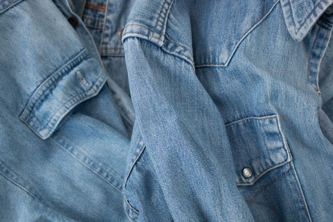 Detailed image of overlapping blue denim jackets showcasing texture and style.