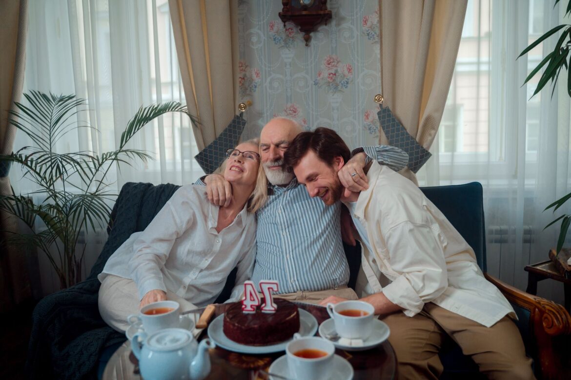 A joyful family celebration with cake and tea, capturing warmth and togetherness indoors.