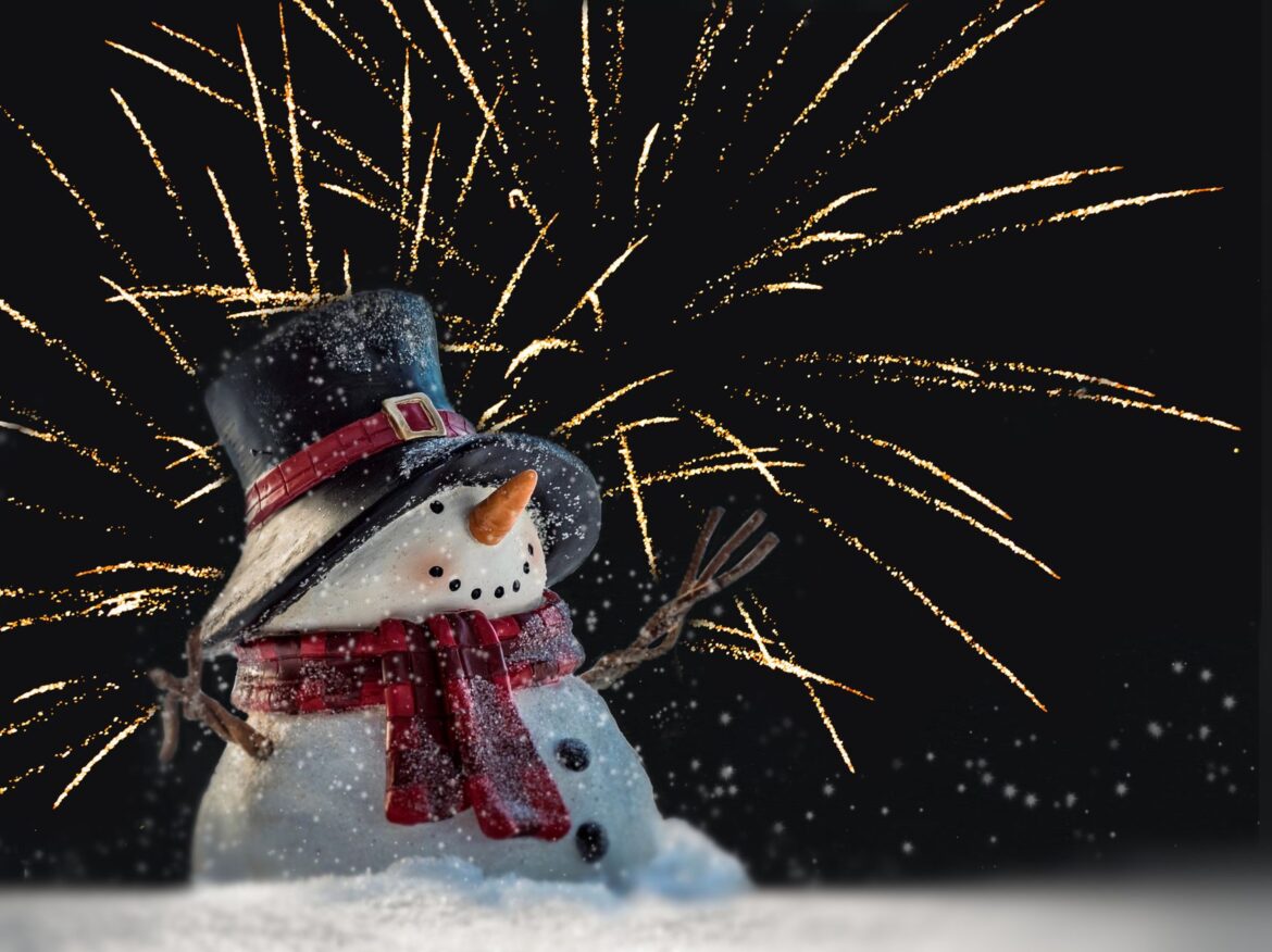Festive winter scene with a snowman and fireworks, perfect for holiday celebrations.