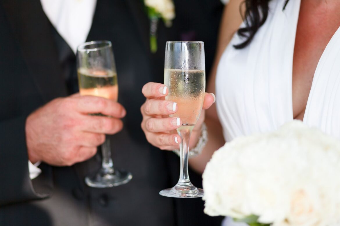 Bride and groom toasting with champagne at their wedding celebration.
