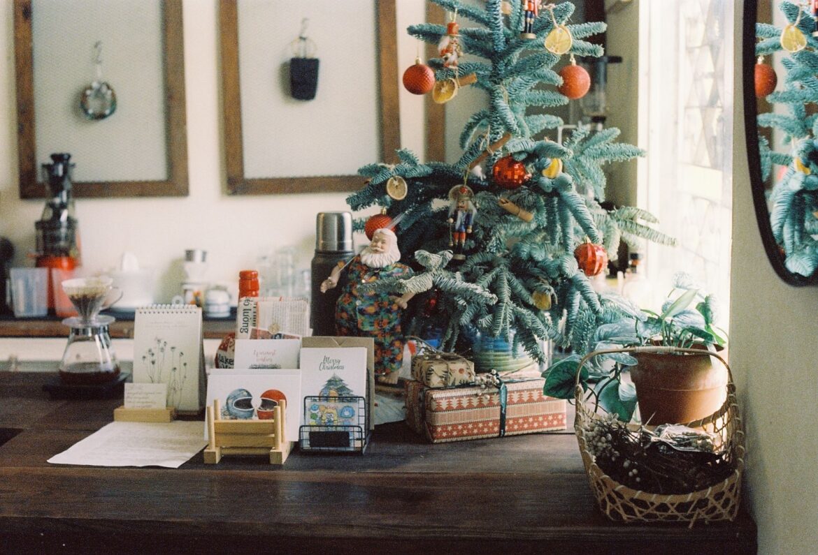 Warm and inviting Christmas home setup featuring a decorated tree, gifts, and greeting cards.