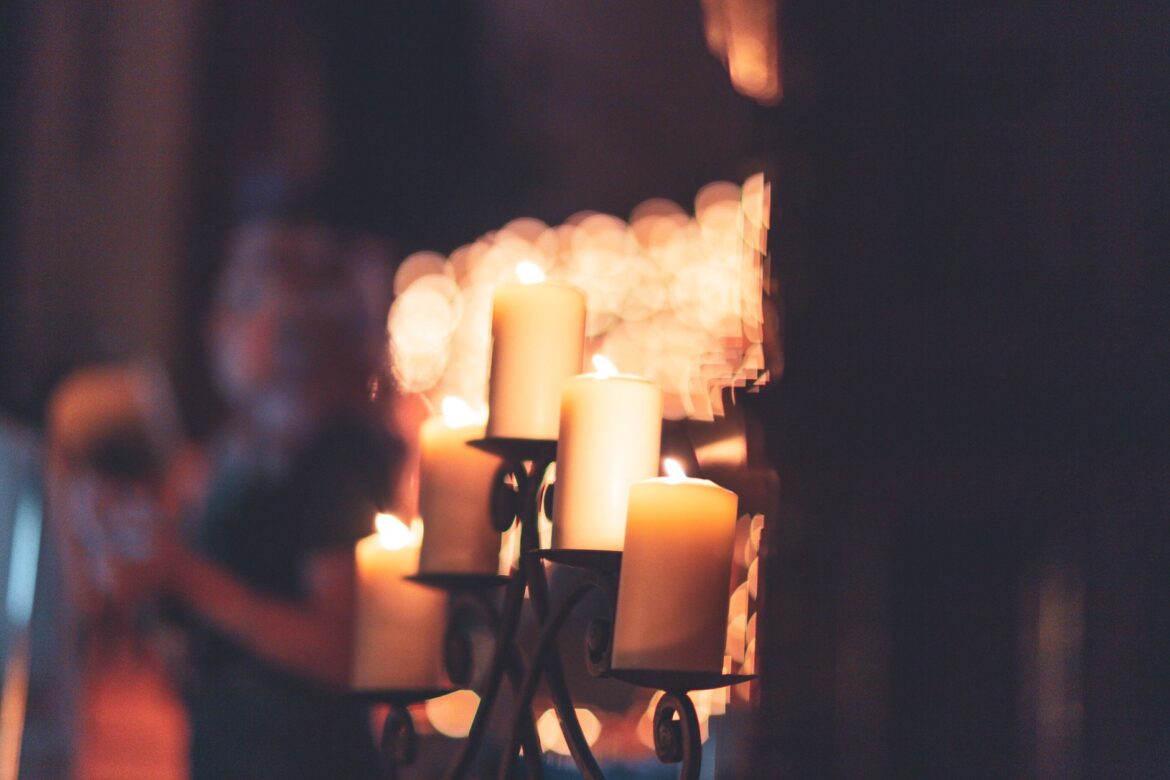 A cozy and intimate setting with candlelight casting a warm glow, perfect for romantic or festive occasions.