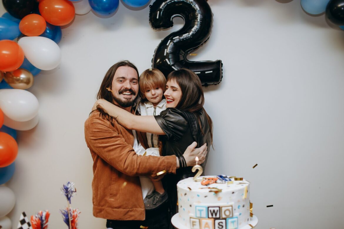 Warm family celebration for child's second birthday with cake and decorations.