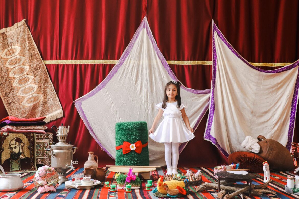 A young girl in a festive setting celebrating Novruz with traditional Azerbaijani decor in Salyan, Azerbaijan.
