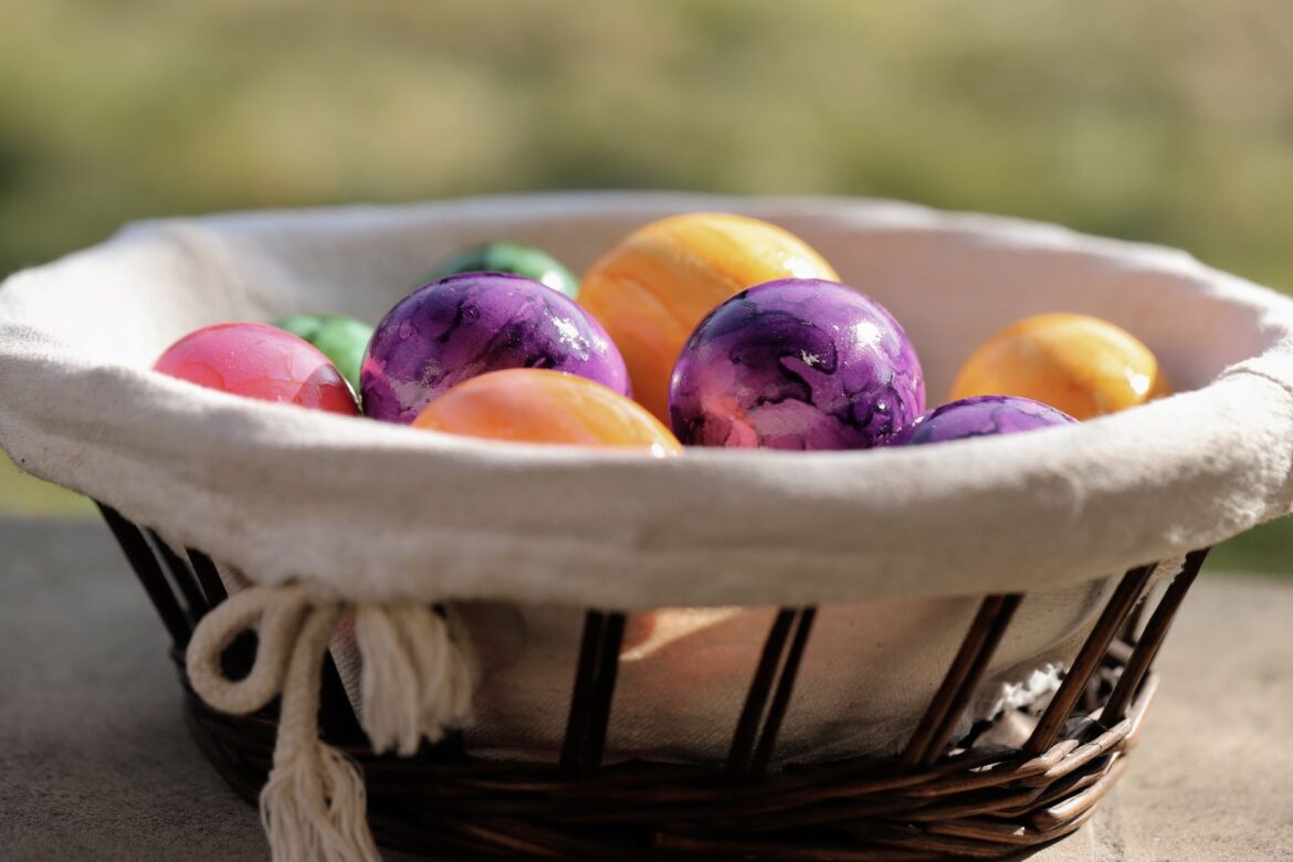 A basket full of colorful Easter eggs, perfect for spring holiday traditions.