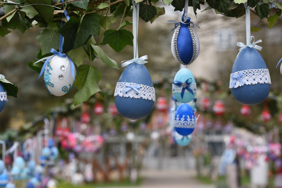 Beautifully decorated Easter eggs hanging on a branch, creating a festive outdoor display.