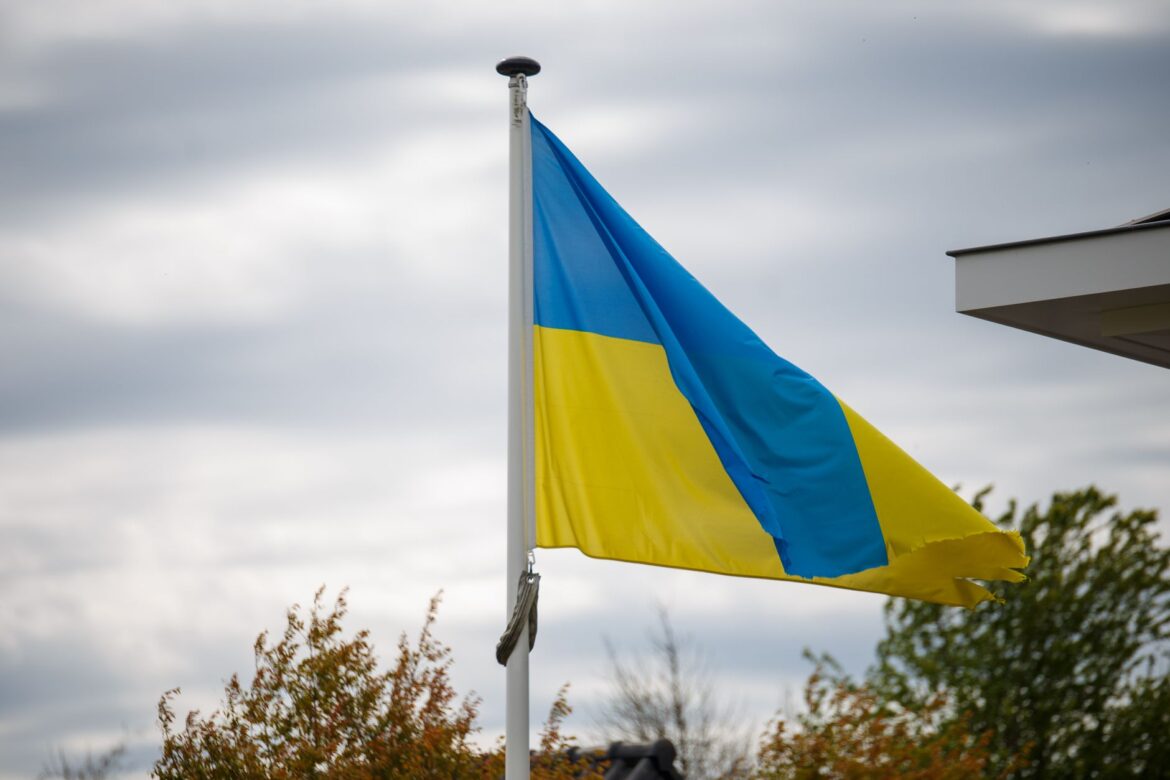 A vibrant Ukrainian flag waving against a cloudy sky, showcasing national pride.