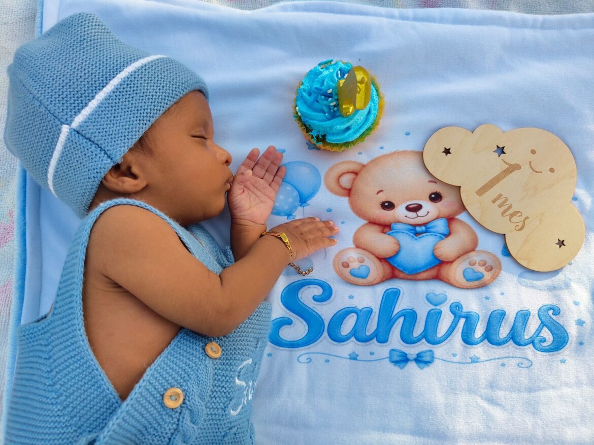 Adorable baby sleeps next to a cupcake, marking their first month milestone. Perfect for newborn themes.