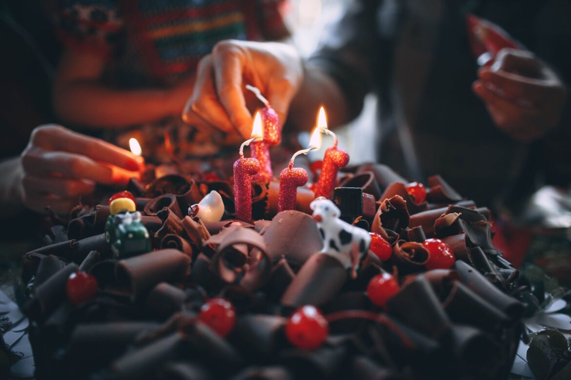 Celebrate a birthday with chocolate cake adorned with lit candles. Perfect for festive occasions.