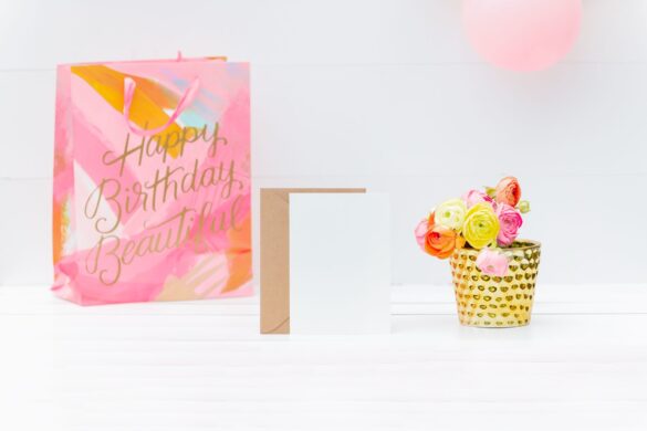Bright and cheerful birthday setup with a gift bag, greeting card, and floral decoration.