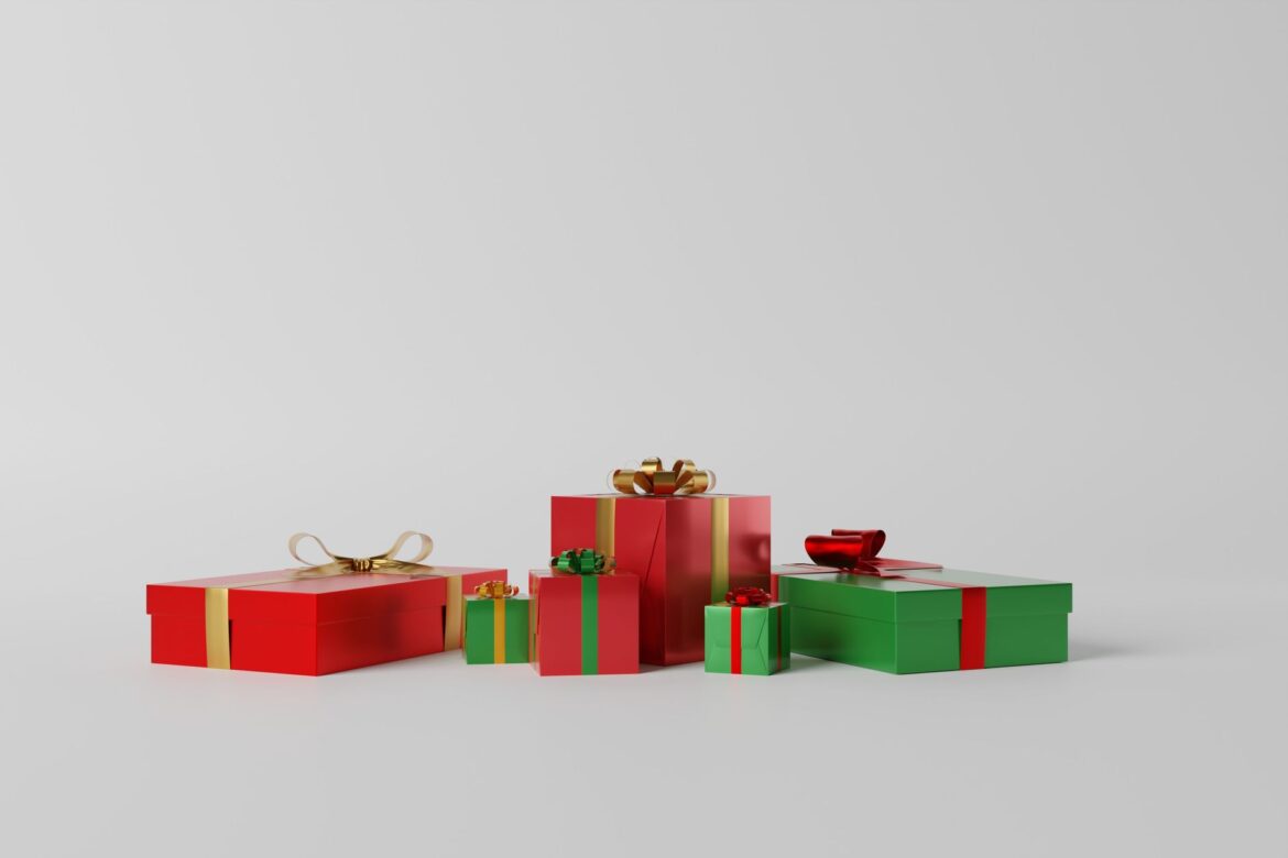 A variety of red and green gift boxes with ribbons on a white background, perfect for celebrations.